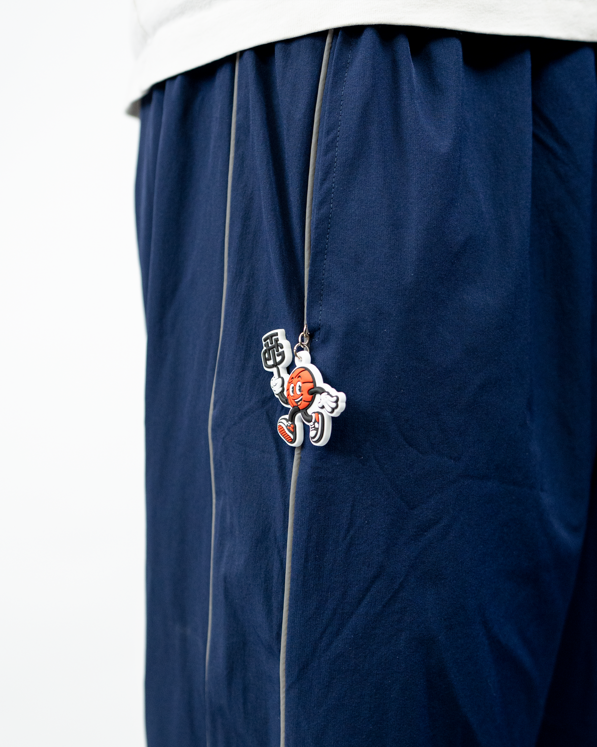 THG Mascot Keychain clipped to Navy Blue Cropped Trackpants