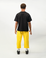 Model wearing THG Yellow Cropped Sweatpants, back view