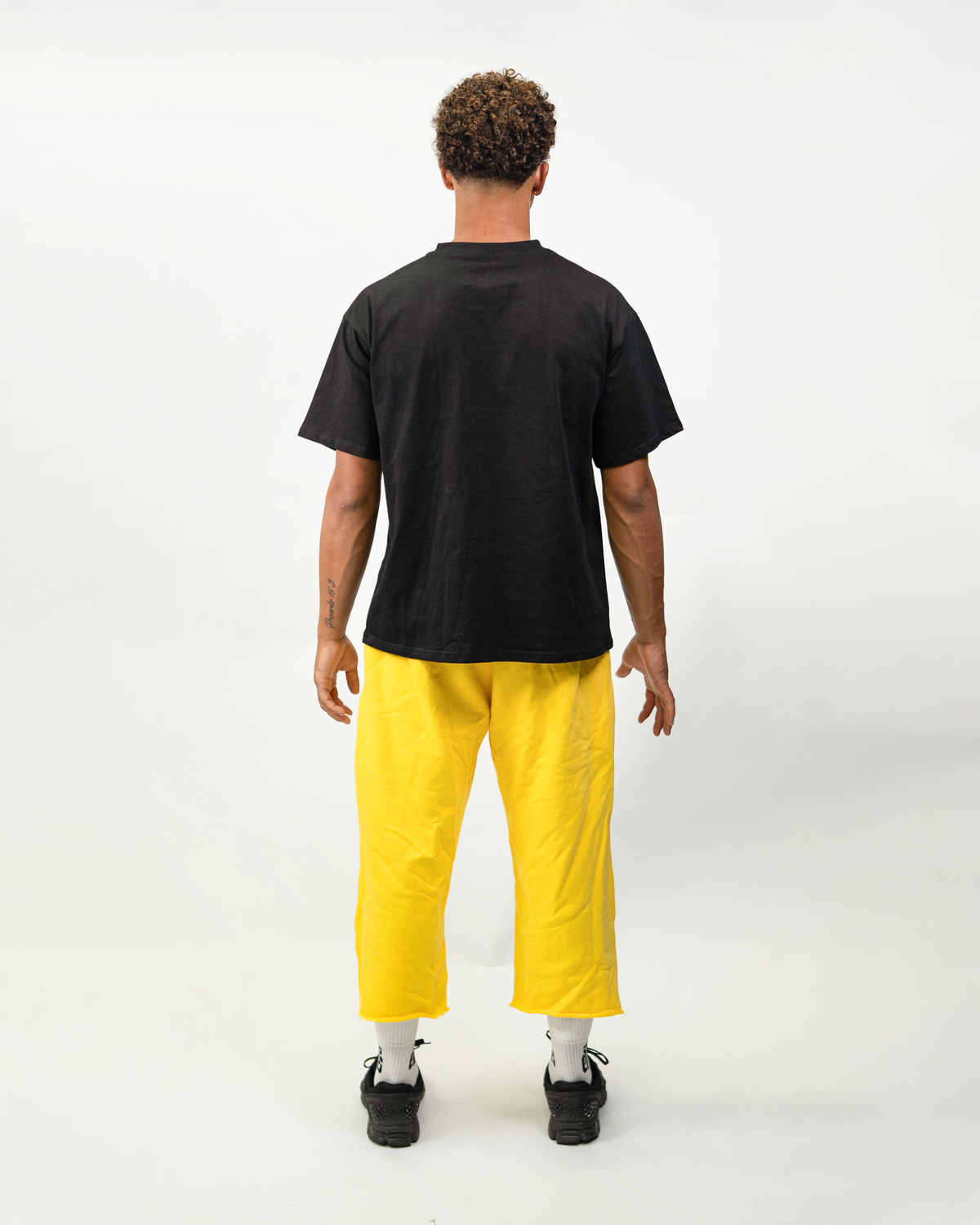 Model wearing THG Yellow Cropped Sweatpants, back view