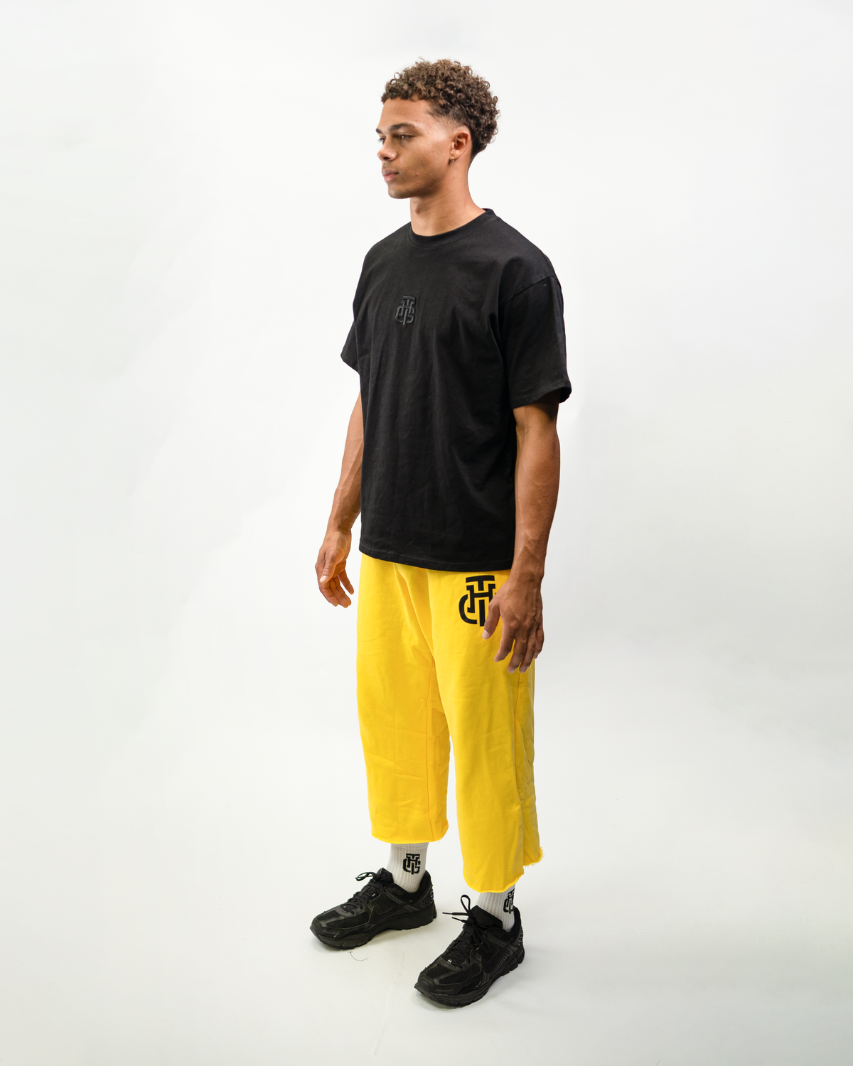 Model wearing THG Yellow Cropped Sweatpants, side view
