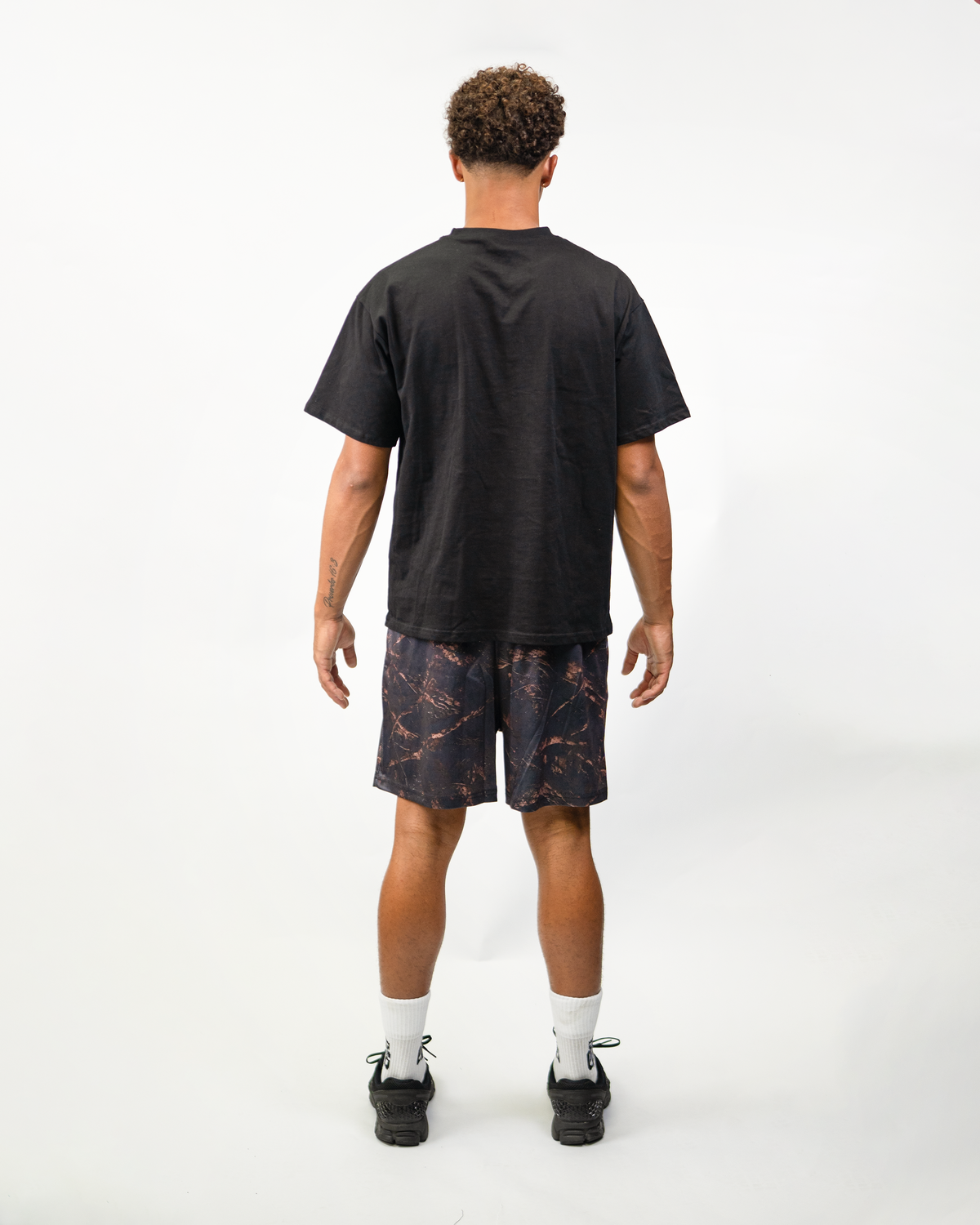 Dark Camo Shorts on model, back view