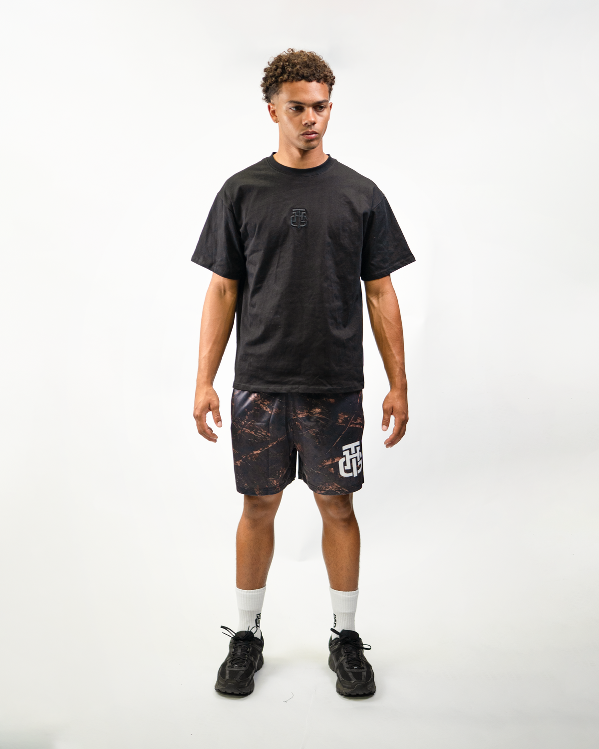 Dark Camo Shorts on model, front view