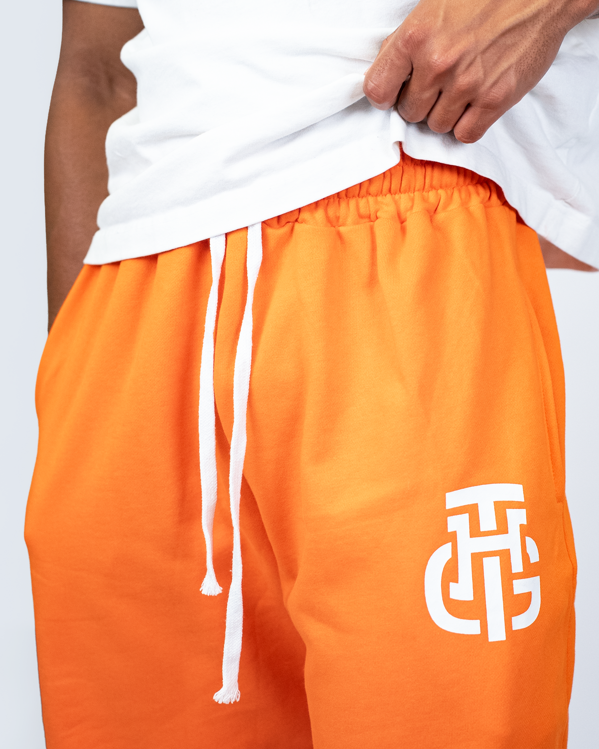 THG ORANGE CROPPED SWEATPANTS