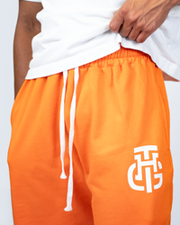 THG ORANGE CROPPED SWEATPANTS